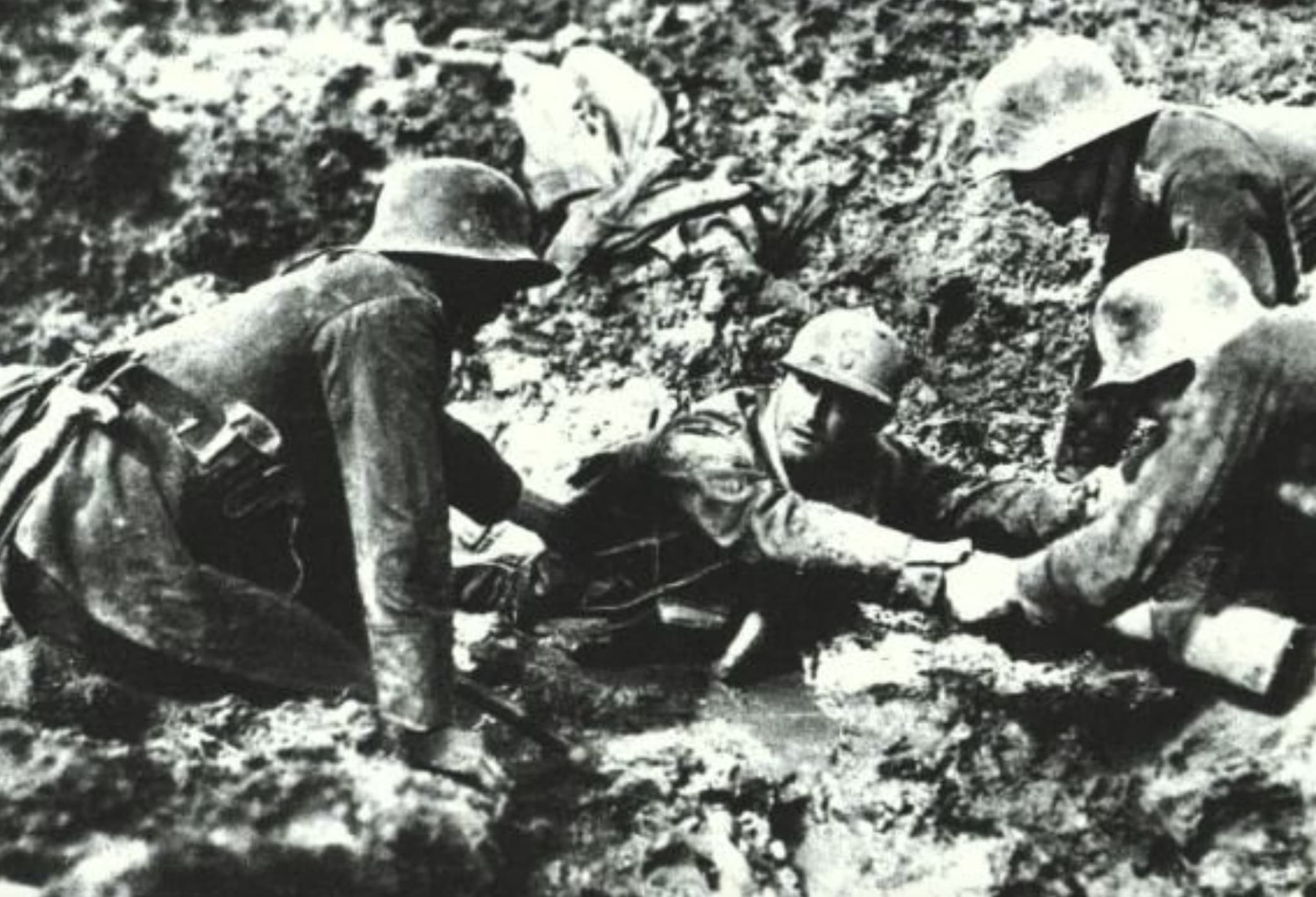 “French soldier being rescue by two german soldier during the climax of the battle of Verdun, 1916.”